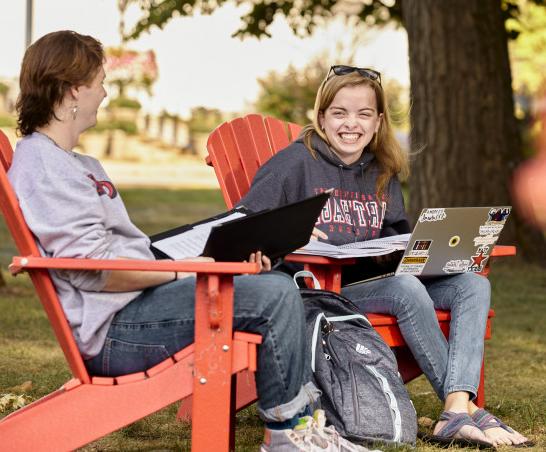 Take a seat! Red adirondack chairs are found all over campus.